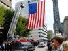 People watching along Virginia Street as the hearse carrying the body of Patrolman Jerry Jones who was killed in the line of duty passes by passes underneath an American Flag.  Photo by Craig Cunningham 9/16/09